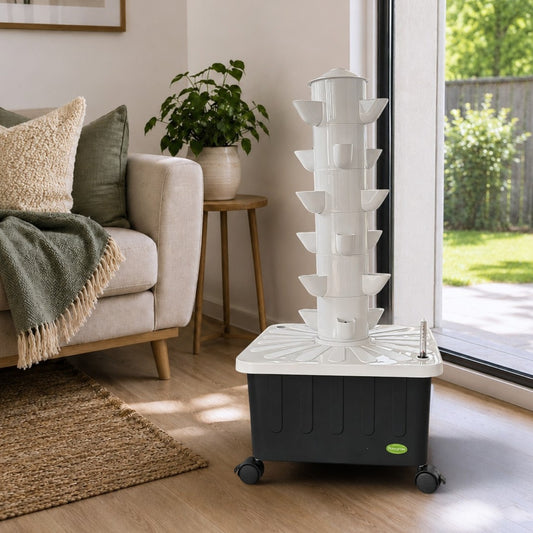FlowGrow 6-layer hydroponic tower in a bright living room beside a sliding door.