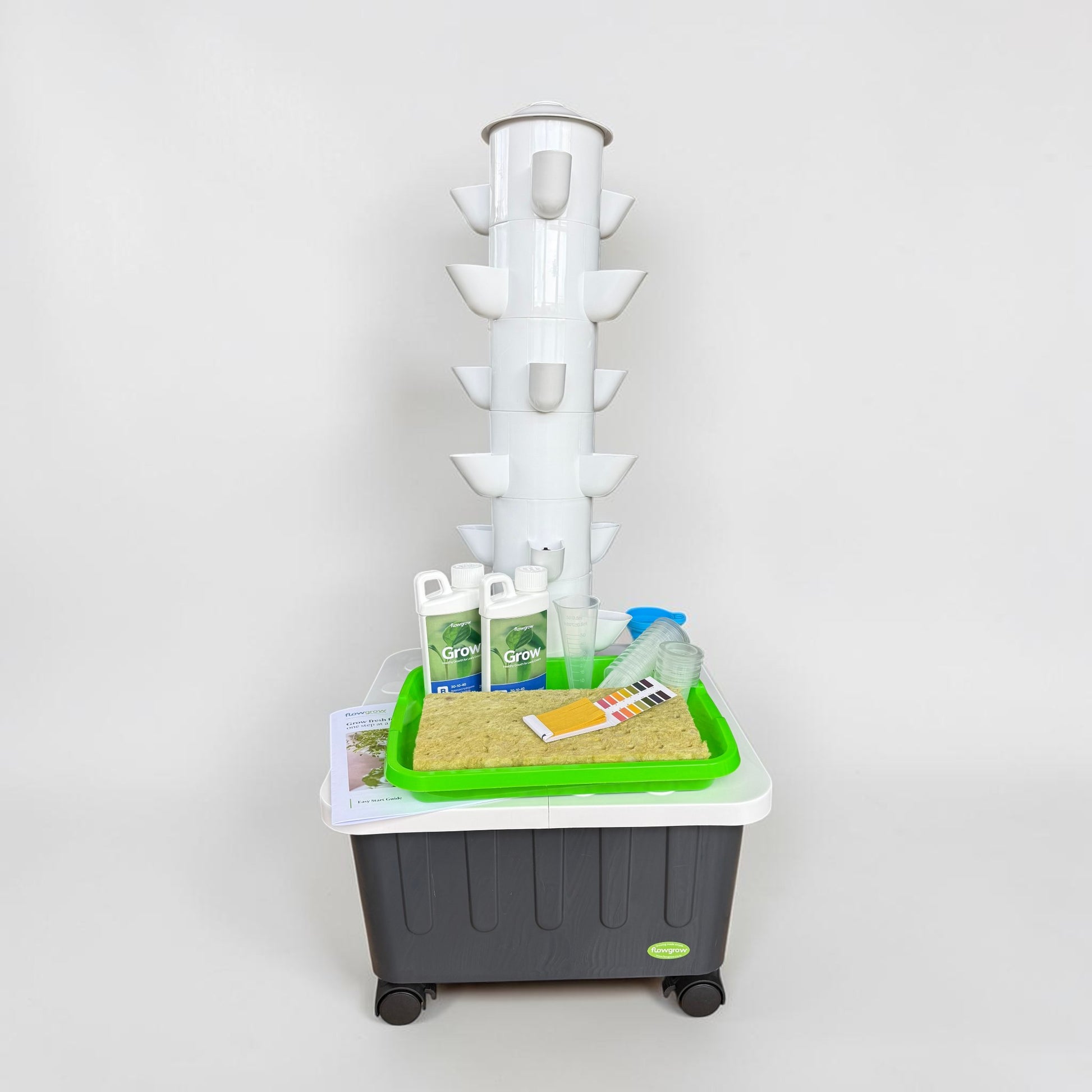 FlowGrow 6 Layer Hydroponic Tower with Starter Kit including Grow nutrients, rockwool cubes, net pots, pH test strips and seed starting essentials.