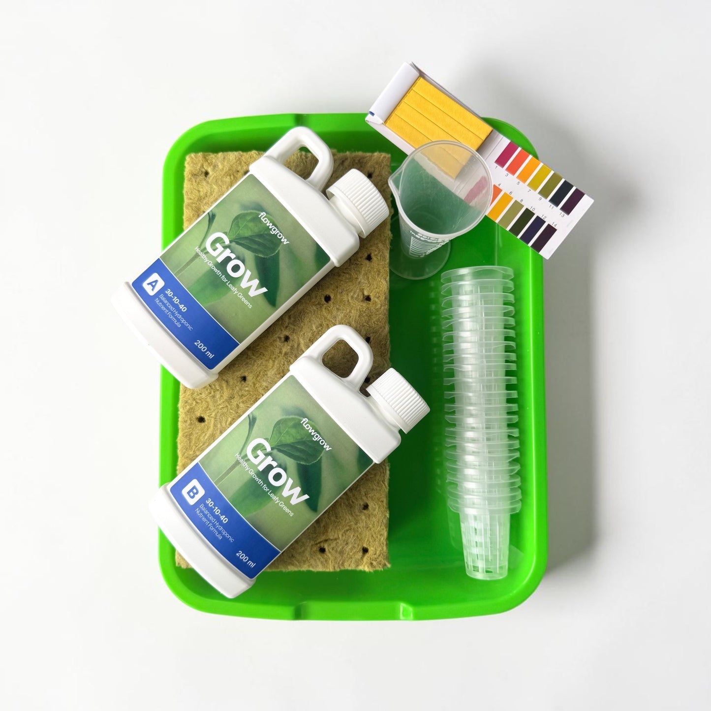 FlowGrow starter kit with nutrients, rockwool cubes, and growing accessories