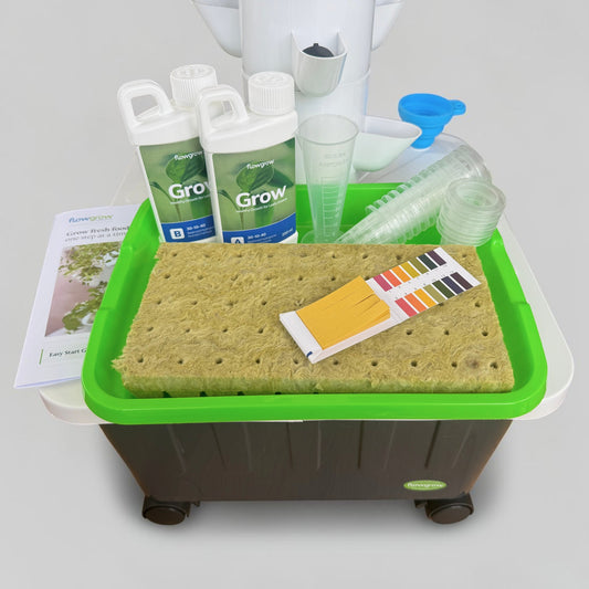 FlowGrow Hydroponic Tower with Starter Kit including Grow nutrients, rockwool cubes, net pots, pH test strips and seed starting essentials.