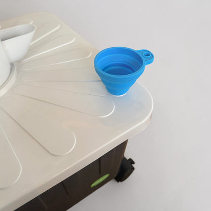 Blue funnel fitted into the FlowGrow tower reservoir lid for easy water and nutrient top-ups.