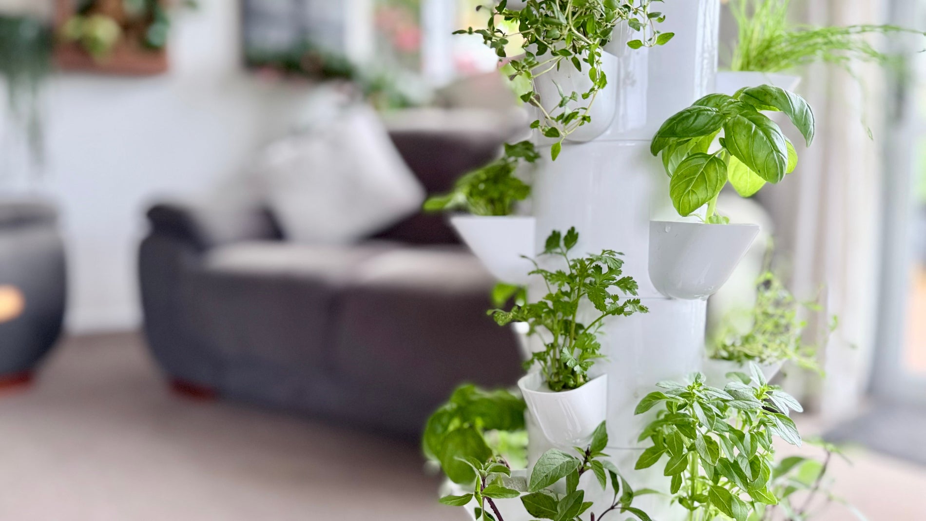 Vertical tower garden with green plants in a living room setting